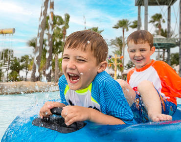 Palm Beach image of two kids riding a tube on the lazy river