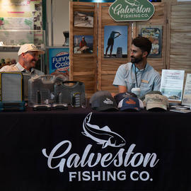 Fly Fishing Film Festival sponsor Galveston Fishing Company vendors joke and chat at the event